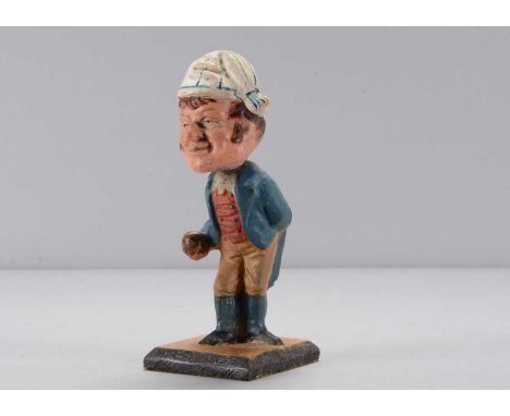 A mid 19th century Thüringen man playing boules or bowling nodder, composition large headed with string chin, white and blue 