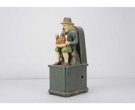 A late 19th century  Black Forest carved wooden clockwork figure of a resting traveller dumpling eating,  the seated older ma