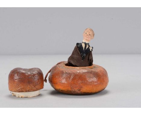 A papier-mâché novelty cottage loaf with pop-up Joseph Chamberlain, circa 1905, a composition headed Chamberlain with monocle