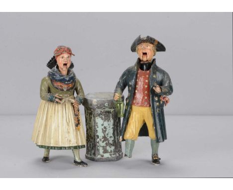 A pair of mid 19th century Rhöner carved wooden and papier-mâché Rhönwackler man and woman nodders, the woman in traditional 