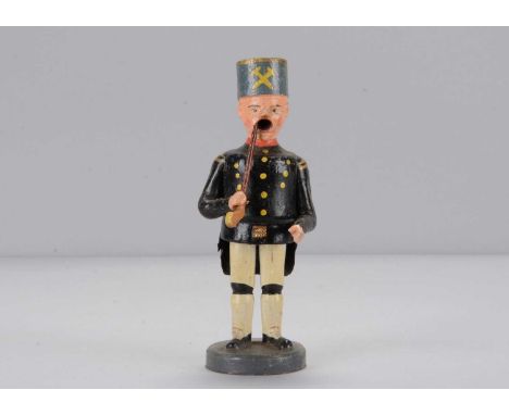 An early 20th century Erzgebirge miner smoker, turned, carved and painted wooden man in ceremonial uniform smoking pipe, open