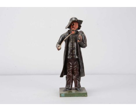 A mid 19th century German papier-mâché vagabond,  possibly a veteran, with hooked nose, thin beard around jawline, cloth hat,
