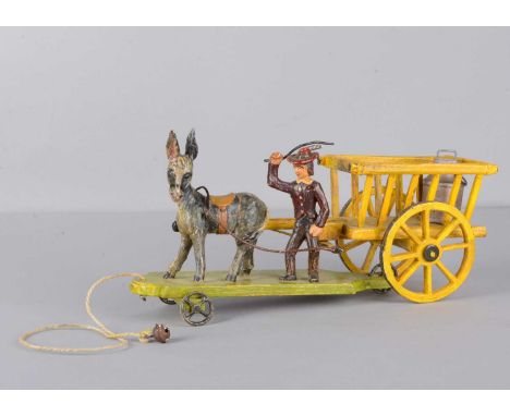 A late 19th century German donkey hay cart with drover,  carved and painted wood, the drover and donkey on green three wheele