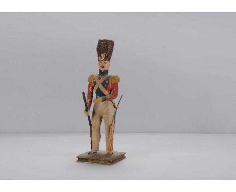 An early 19th century papier-mâché Napoleonic English Infantryman,  with busby, blue painted eyes, brown painted moustache, o
