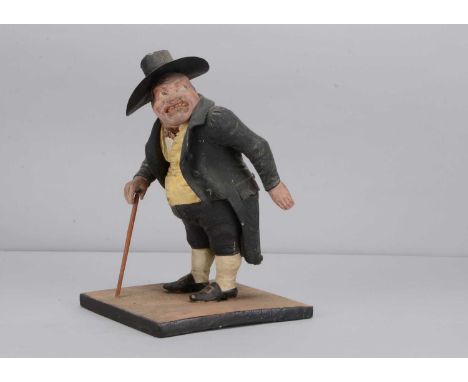 A mid 19th century Thüringen papier-mâché figure of an angry man match striker, with head turned to the left, heavily furrowe