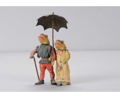 A late 19th or early 20th century Heyde-type lead frog couple nodder,  anthropomorphic painted frogs walking along arm in arm