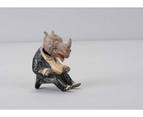A late 19th or early 20th century Heyde-type lead seated rhinoceros nodder,  anthropomorphic painted rhino in black tail suit