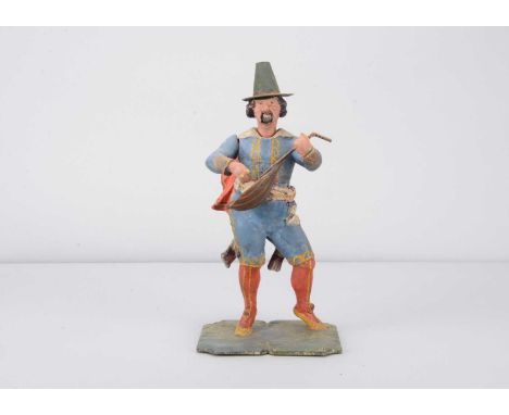 A mid 19th century Thüringen papier-mâché traveling minstrel nodder,  with nodding head, articulated mouth and strumming arm,