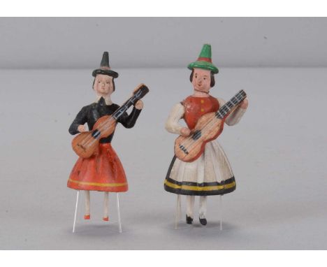 Two late 19th century German bristle dancing toys, two wood and composition women in pointed hats playing a guitar, articulat