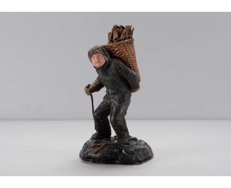 A mid 19th century Thüringen boy faggot gatherer,  composition with light brown painted eyes, black suit with fur trimmed hat