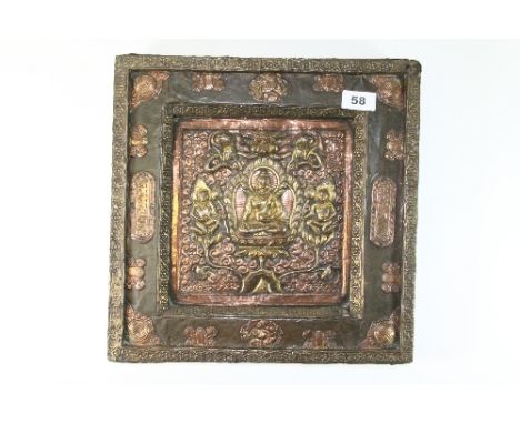 A superb 19th century Tibetan hammered and gilt brass and copper icon mounted over wood with ruby eyes to the dragon, 34cm x 