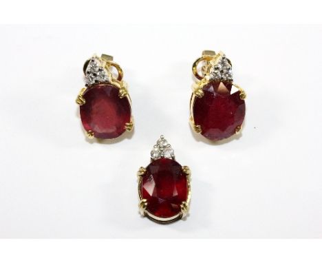 A 14ct gold mounted ruby and diamond pendant and earrings set (rubies approx 25ct total)
