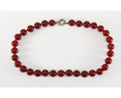 A single strand necklace of 11.5mm red jade beads