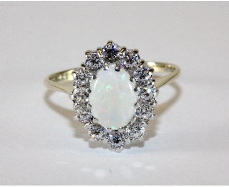 A 9ct gold opal and stone set cluster ring (L)