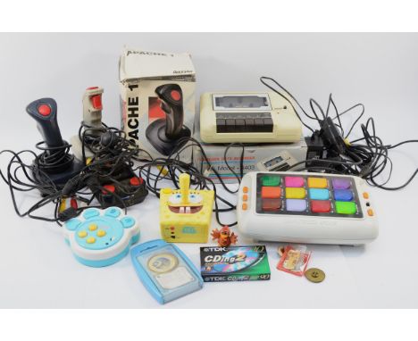 An assortment of vintage gaming accessories, to include, a Spongebob Squarepants joystick, a Cheetah Annihilator, a Radioshac
