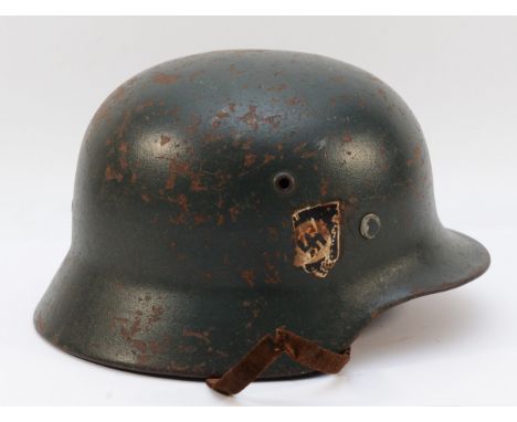 A German WWII steel helmet, double decal, leather strapped, numbered SE62, 4846 and 'Zietman' initialised inside.