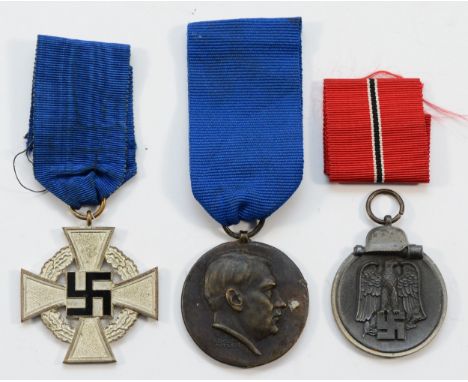 A German Third Reich 15 year National Faithful Service Medal, metal and enamel, with silk ribbon, a Winter Campaign 1941/42 E