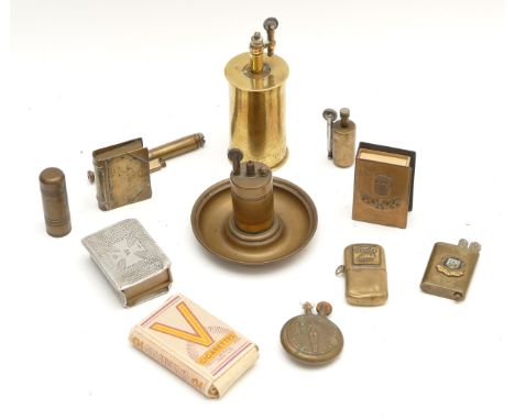 A collection of trench art, to include pocket and table cigarette lighters, together with two matchbox holders, one inscribed