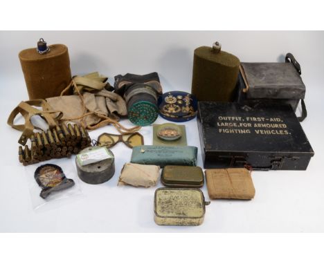 Two pre WWII 1938 gas masks, two canteens, a military first aid box, stamped with the broad arrow, as well as survival suppli