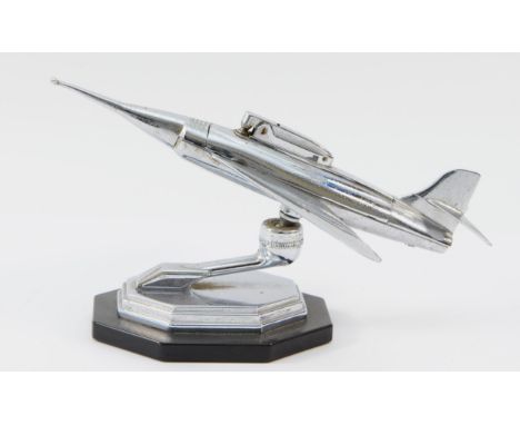 A Jet Age chrome fighter jet table lighter, c.1950,s, on black Bakelite base, height to tallest point 11.5cm, length 23.5cm.