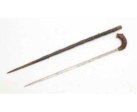 An early 20th century Indian ebony and brass sword stick, with carved tigers head handle and brass pointed terminal, 89cm