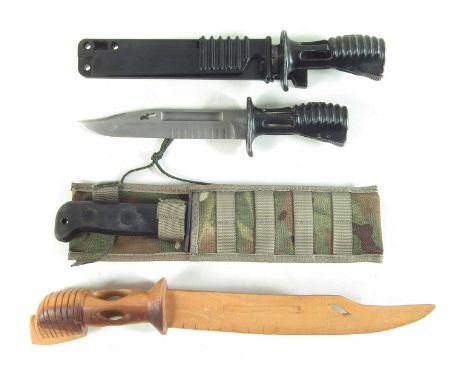 Two SA80 bayonets, one with scabbard, also a carved wood copy and a J.Adams 1999 board arrow marked survival knife in camoufl