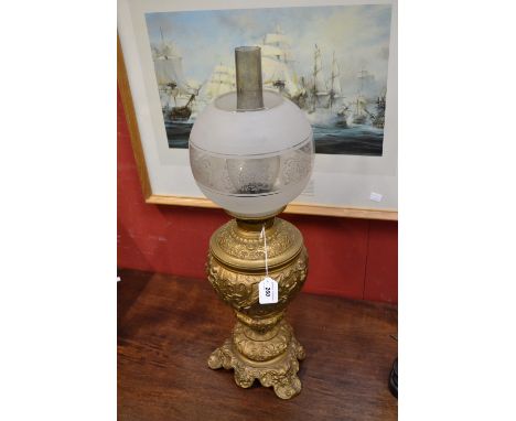 A large Victorian oil lamp, playful cherubs and satyr mask feet