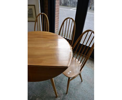 An elm Ercol dropleaf table and four spindleback chairs. (5)