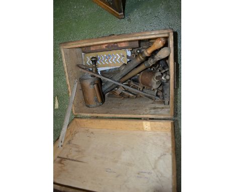An early 20th century pine tool box, hinged cover; tools; blow torch garden syringes; crow bar; etc.