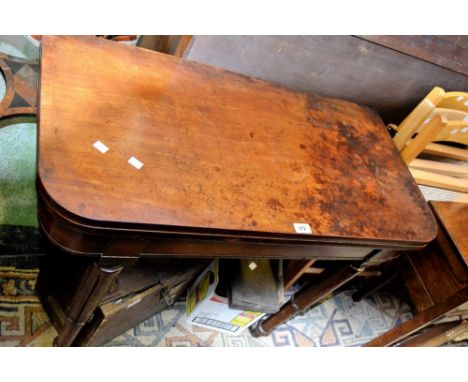 A Regency mahogany card table, fold over top, opening to green baize playing surface, tapering legs, brass casters