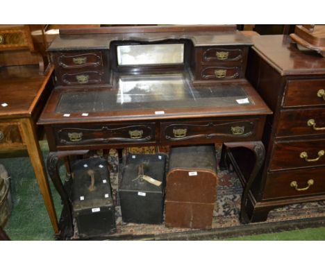 A late Victorian mahogany writing table, four drawers, shelf and mirror to superstructure, leather inlaid top, two drawers to