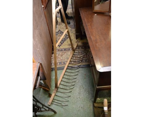 A vintage agricultural Bonny hay rake.