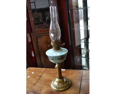 A Victorian oil lamp, brass column, Art Nouveau style reservoir.