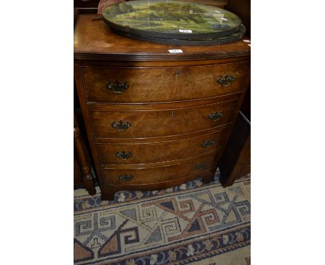 A reproduction burr walnut bow front chest of small proportions, crossbanded and reeded top, four cockbeaded drawers, brass b