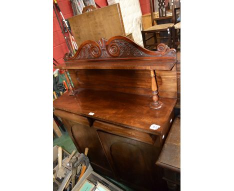 An Edwardian mahogany chiffonier, scrolling arched pediment and shelf to superstructure, two drawers over two arched panel do