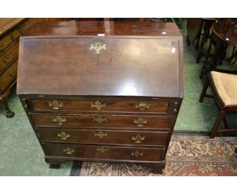 A George III oak bureau, fall front enclosing fitted interior over four drawers, bracket feet.