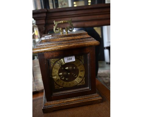 An oak cased striking mantel clock, twin winding holes