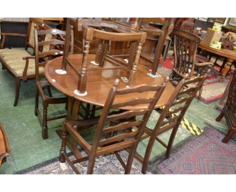 An oak dropleaf table, oval top, lyre end supports; two ladder back carvers; four ladder back chairs (7)