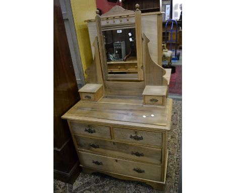 A late Victorian dressing chest, turned finials and spindles to mirror frame, rectangular glass, two short drawers to superst