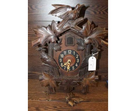 IMPRESSIVE CARVED WOOD BLACK FOREST STYLE ONE DAY CUCKOO CLOCK
with an intricately carved bird pediment over the cuckoo windo