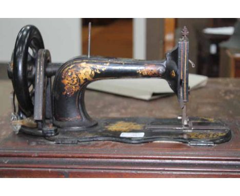 SINGER SEWING MACHINE AND A WOODEN SLICING TOOL