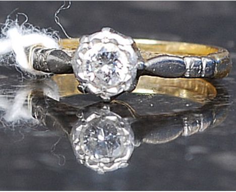 An 18ct gold platinum and diamond ring. The central stone approx 20pnts set within platinum mount.  Total weight 2.9g Size I