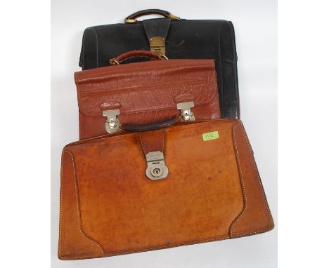 A collection of three vintage leather briefcases