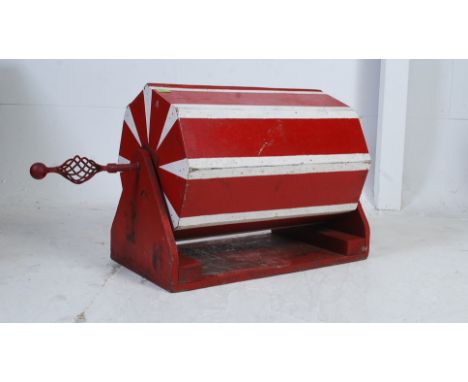 A vintage 1950's painted tombola having hexagonal barrel with twist handle over base being painted red and white. Measures:52