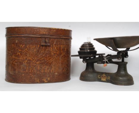 A set of vintage cast iron grocers - industrial scales bearing GR royal cipher together with a vintage tin hat box, possibly 