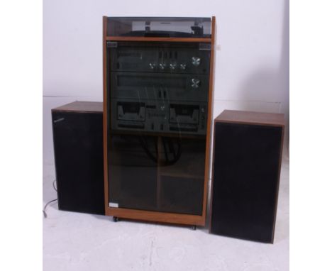 A vintage Amstrad 1980's Hi Fi comprising of record deck, tape deck, receiver, in original cabinet with a pair of speakers. W