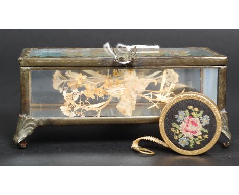 A vintage decorative bevelled glass jewellery casket with inset pressed flower decoration. Together with a vintage embroidere