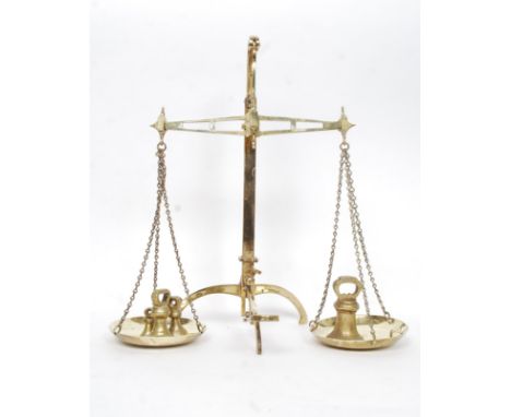 A good pair of Victorian brass weighing scales, with shaped tripod base. Along with a set of four original brass weights. H52
