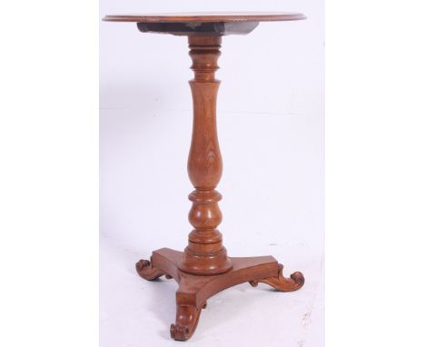 A 19th century Victorian elm wood tilt top tripod wine table. The circular top with tilt mechanism on turned column with tref