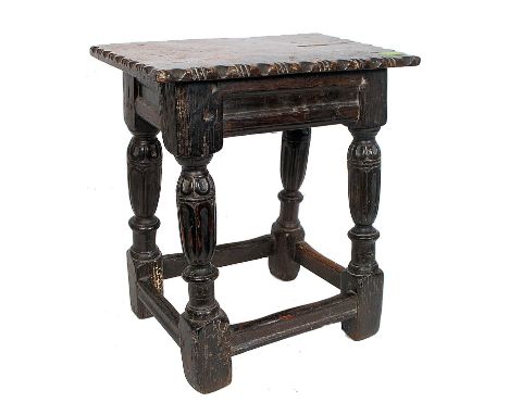 An early English Elizabethan oak joint stool believed, circa 1600. The stool of peg joint construction having fluted cup and 